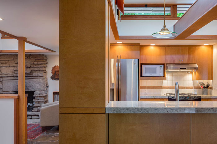 Frank Lloyd Wright inspired home Seattle - kitchen with peak of living room